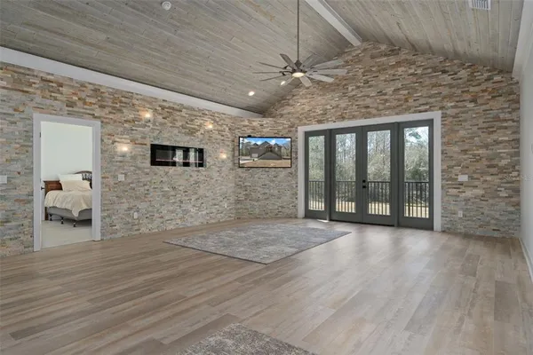 an empty room with wooden floor a chandelier and closet
