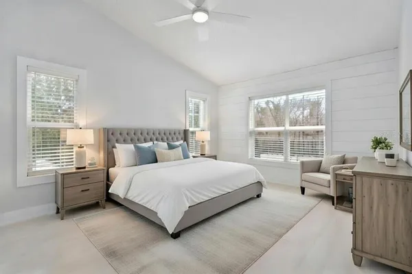 a spacious bedroom with a bed and a window