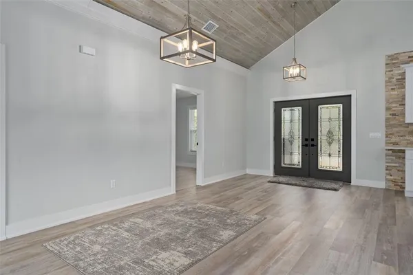 a large bed sitting in a bedroom next to a window