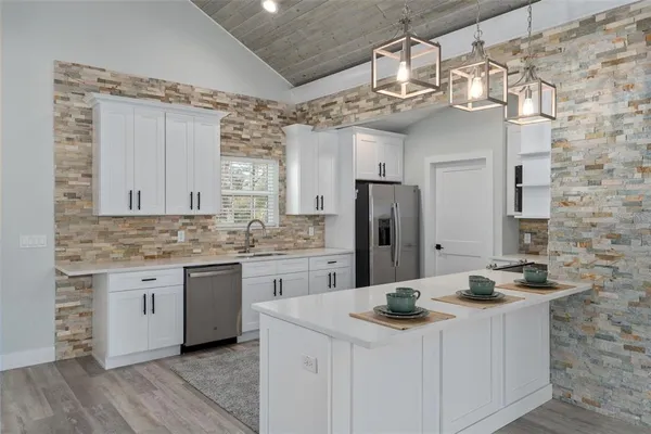 a bathroom with a sink a toilet and a shower