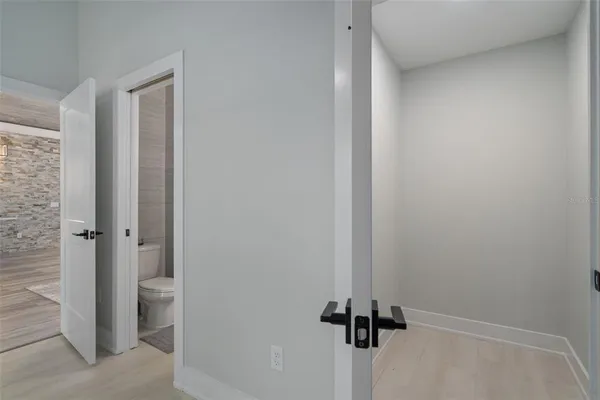 an aerial view of residential houses with outdoor space and trees