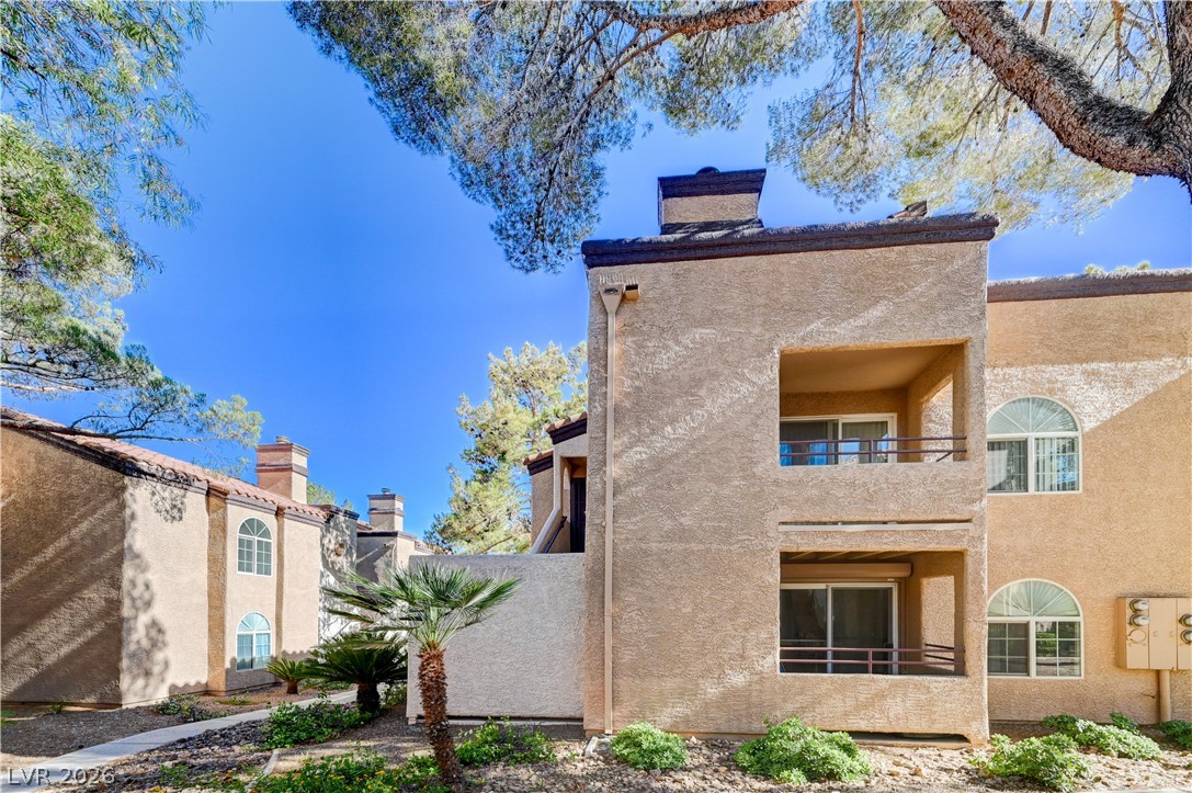 9325 West Desert Inn Road, Unit 226 Las Vegas, NV 89117 - Photo 29 of 29 Multi-level residential units blend seamlessly with the natural desert landscaping, providing private outdoor spaces.