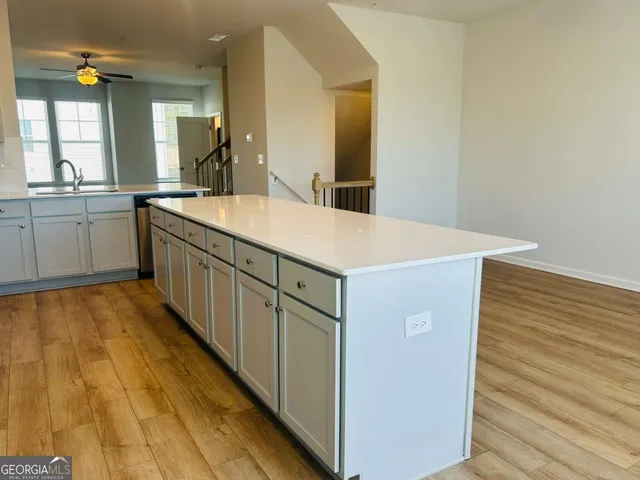 a spacious bathroom with a sink and a mirror