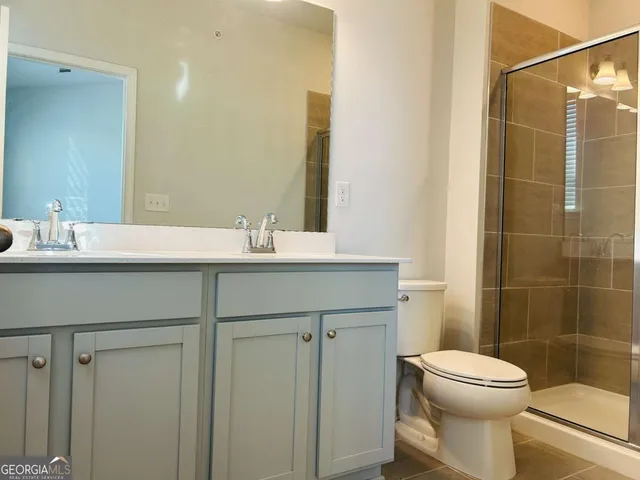 a bathroom with a shower and toilet