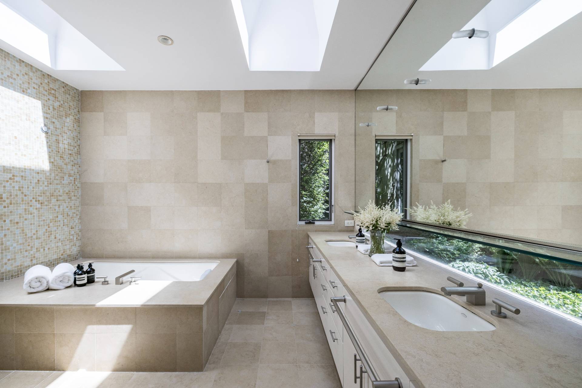4 Baiting Hollow Road East Hampton, NY 11937 - Photo 14 of 30 a bathroom with a tub sink and mirror