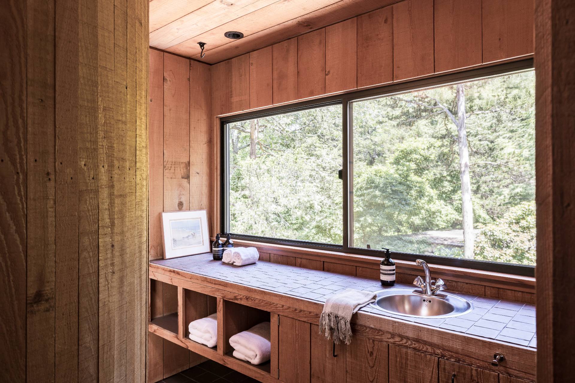 4 Baiting Hollow Road East Hampton, NY 11937 - Photo 16 of 30 a bathroom with a sink and a window