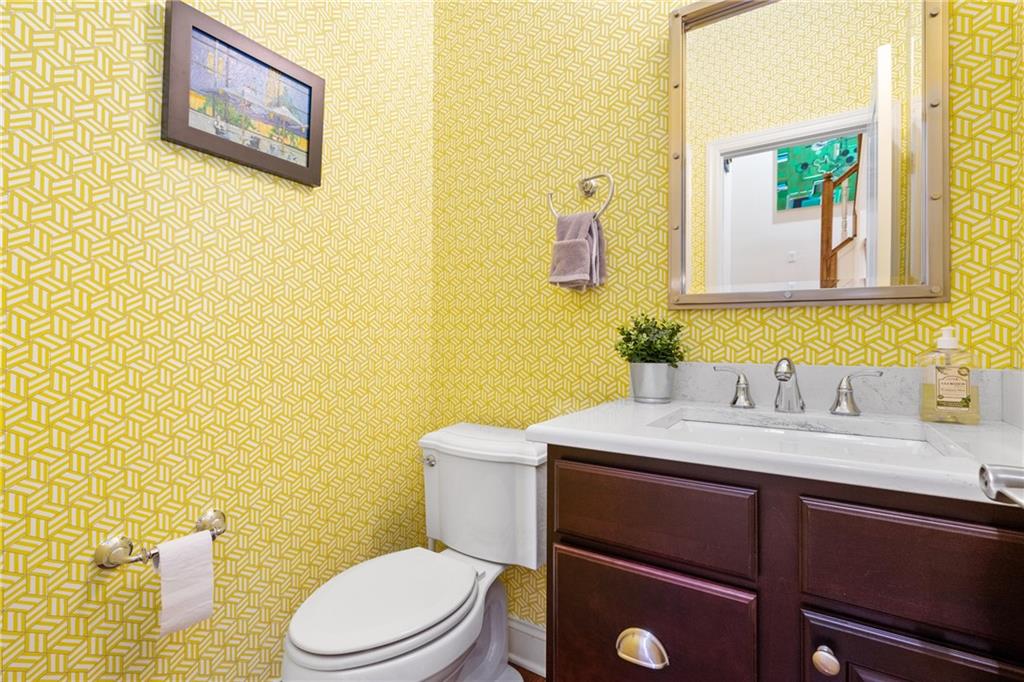 4709 Wallingford Street Pittsburgh, PA 15213 - Photo 11 of 24 a bathroom with a granite countertop toilet sink and mirror