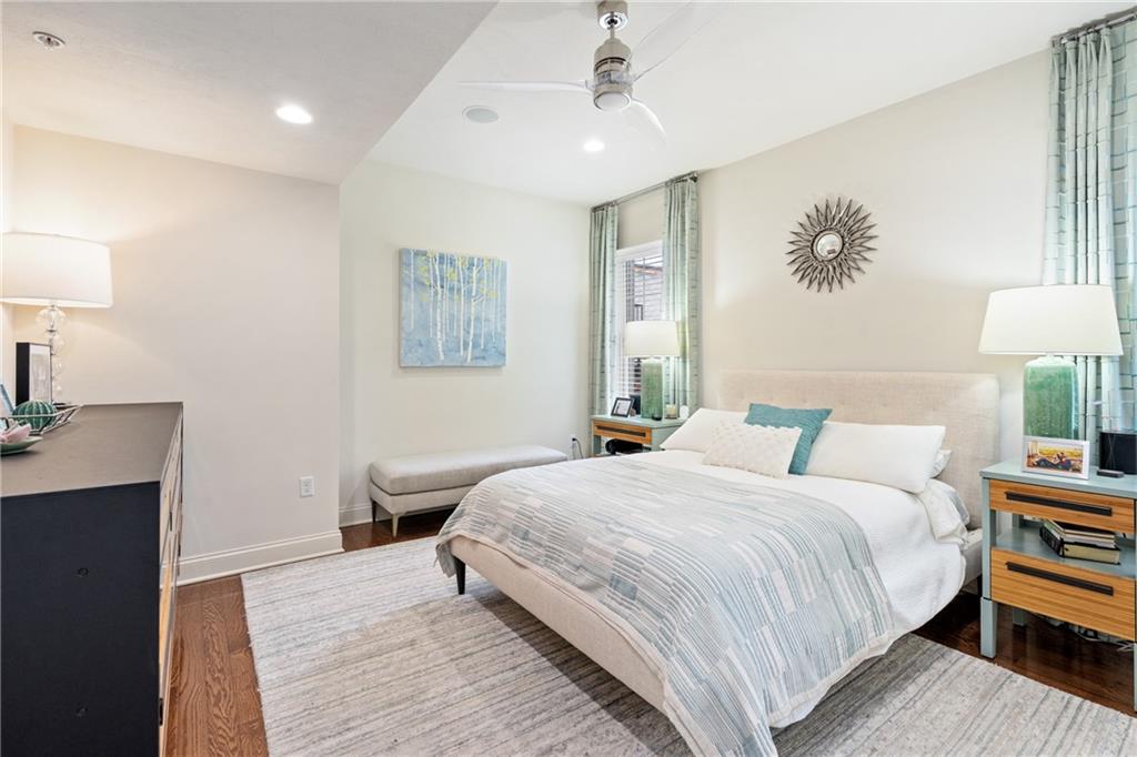 4709 Wallingford Street Pittsburgh, PA 15213 - Photo 13 of 24 a bedroom with a large bed a chandelier and a window