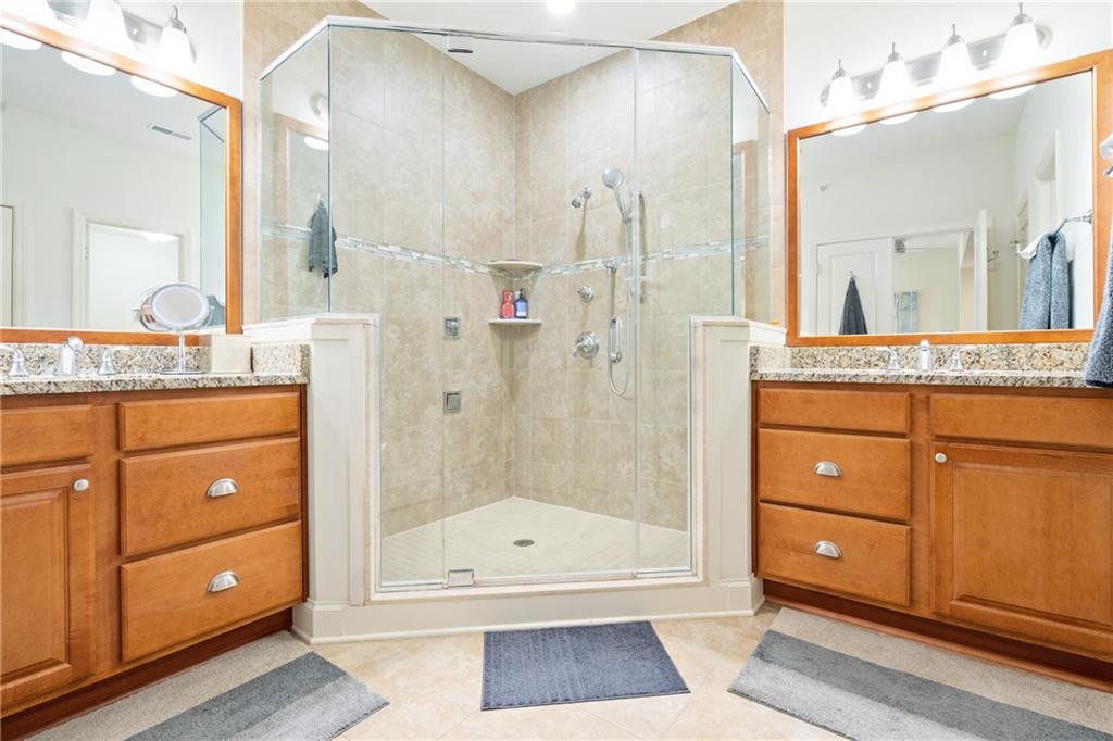 4709 Wallingford Street Pittsburgh, PA 15213 - Photo 15 of 24 a bathroom with a granite countertop sink a mirror and a shower