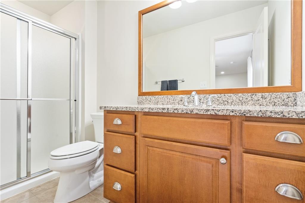4709 Wallingford Street Pittsburgh, PA 15213 - Photo 23 of 24 a bathroom with a granite countertop toilet and a sink