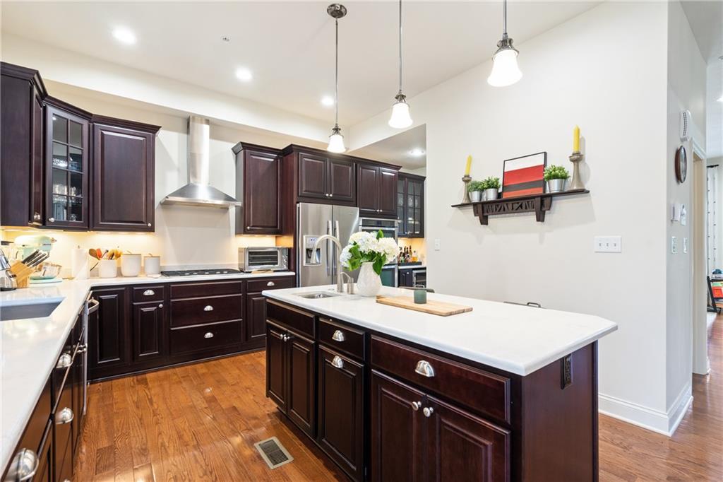4709 Wallingford Street Pittsburgh, PA 15213 - Photo 8 of 24 a kitchen with kitchen island granite countertop a sink appliances and cabinets