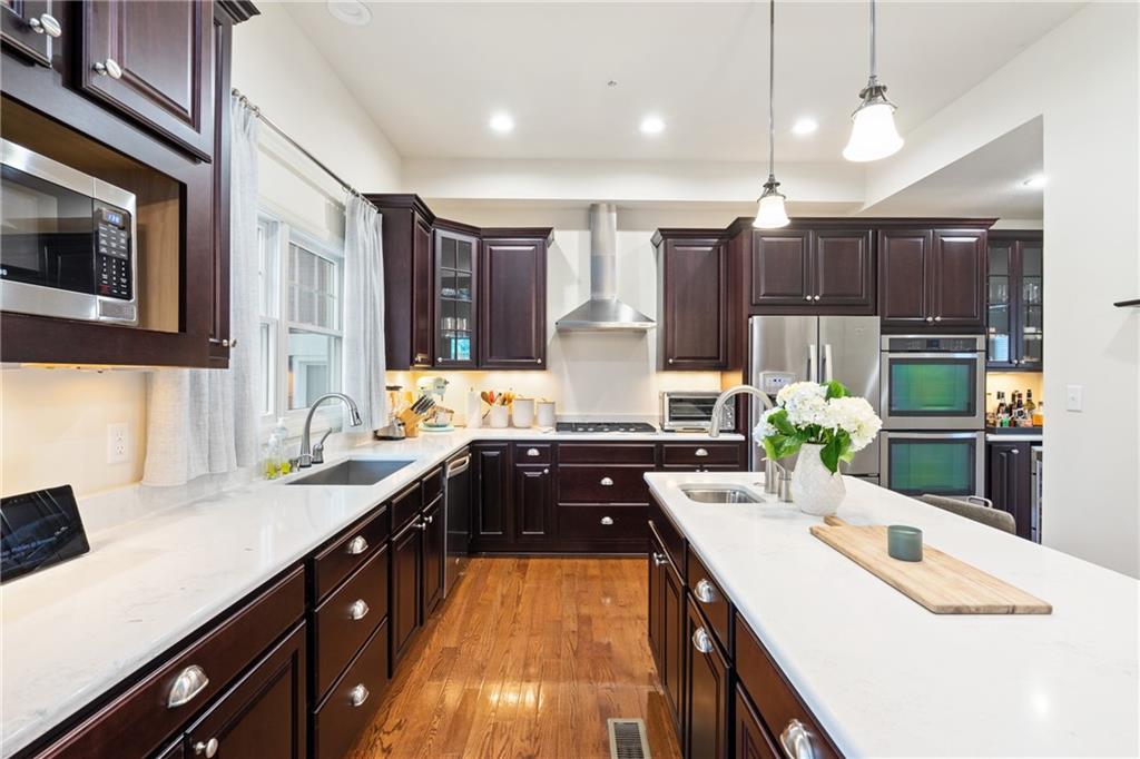 4709 Wallingford Street Pittsburgh, PA 15213 - Photo 9 of 24 a kitchen with kitchen island granite countertop a sink counter top space appliances and cabinets