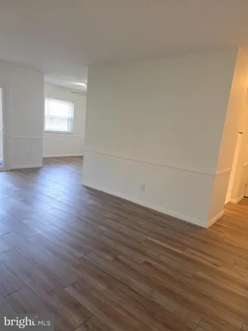 a view of an empty room and wooden floor