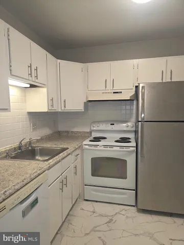 a white refrigerator freezer sitting in a kitchen