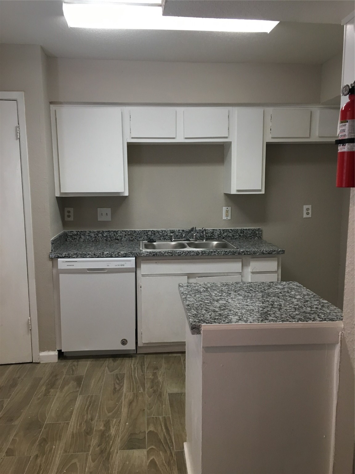 6200 West Tidwell Road, Unit 806 Houston, TX 77092 - Photo 2 of 10 a kitchen with granite countertop a sink and a stove