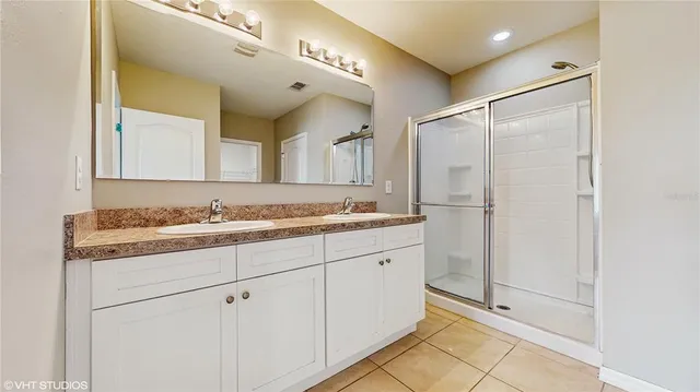 a bathroom with a granite countertop sink mirror and a