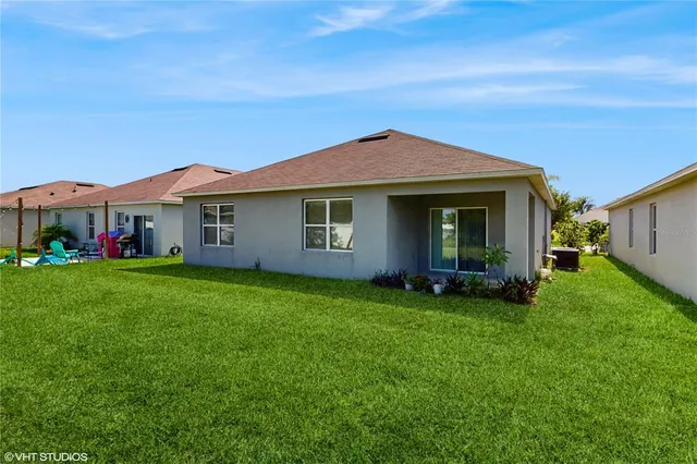 a view of a house with a backyard