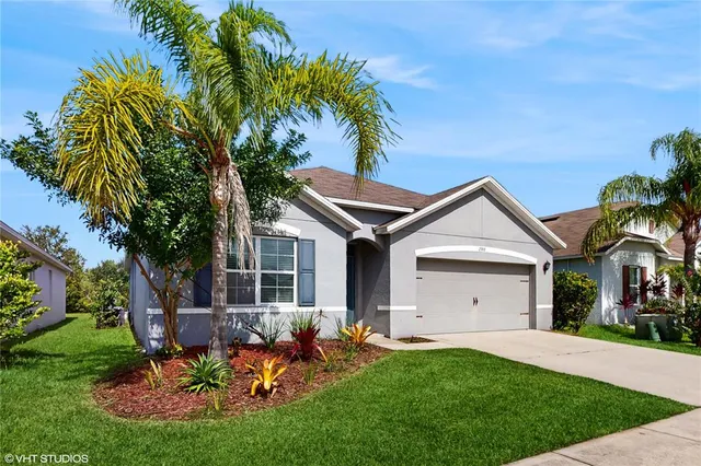 a view of a house with backyard and sitting area