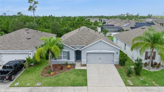 an aerial view of a house with garden space and lake view