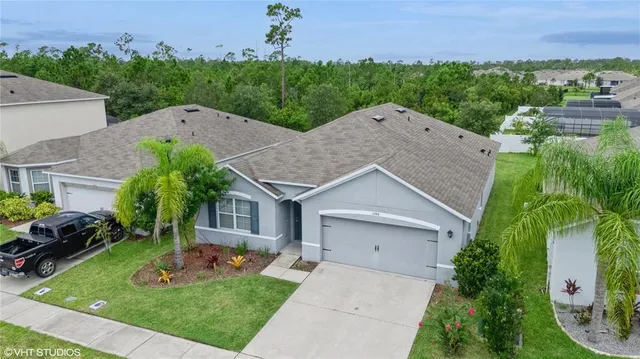 an aerial view of a house with a yard and garage