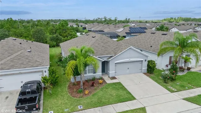 an aerial view of a house with garden space and street view