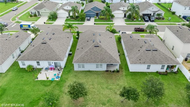 an aerial view of a house with table and chairs