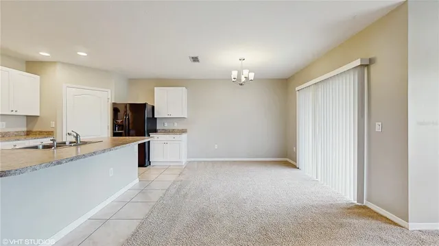 a large kitchen with cabinets and stainless steel appliances