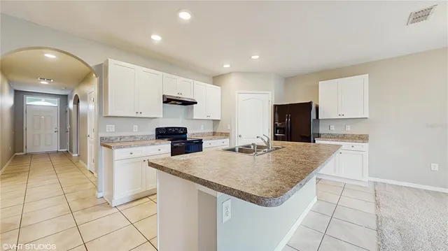 a kitchen with granite countertop a sink and cabinets