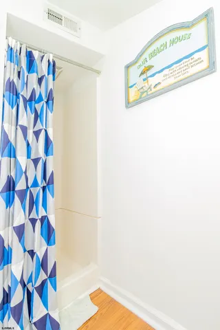 a picture of a bathroom with a shower curtain