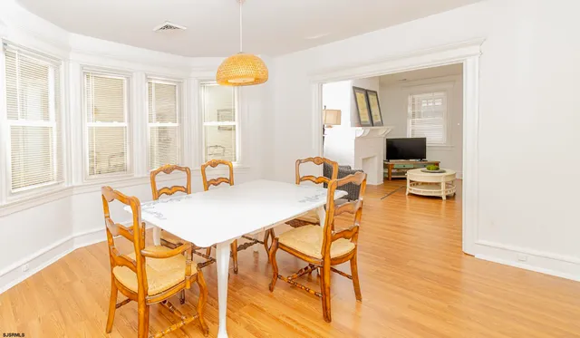 a view of a dining room with furniture and a window