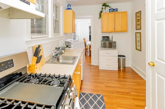 a bathroom with a sink a bathtub and next to a window
