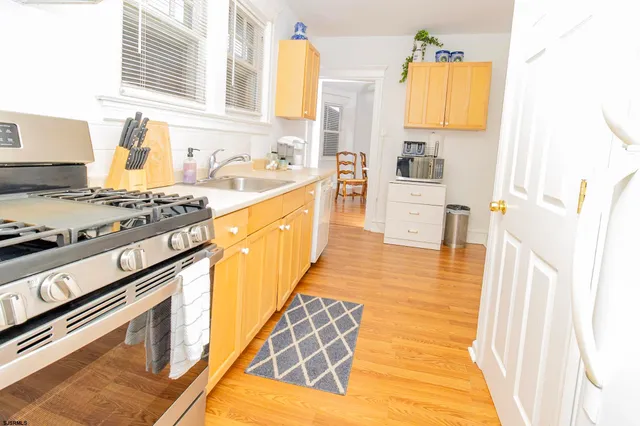a kitchen with stainless steel appliances granite countertop a stove and a sink