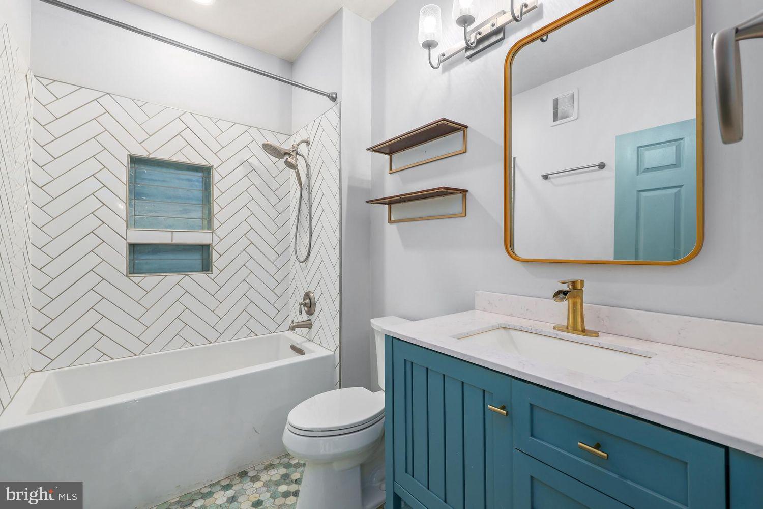 9480 Virginia Center Boulevard, Unit 329 Vienna, VA 22181 - Photo 13 of 30 a bathroom with a sink a toilet and shower