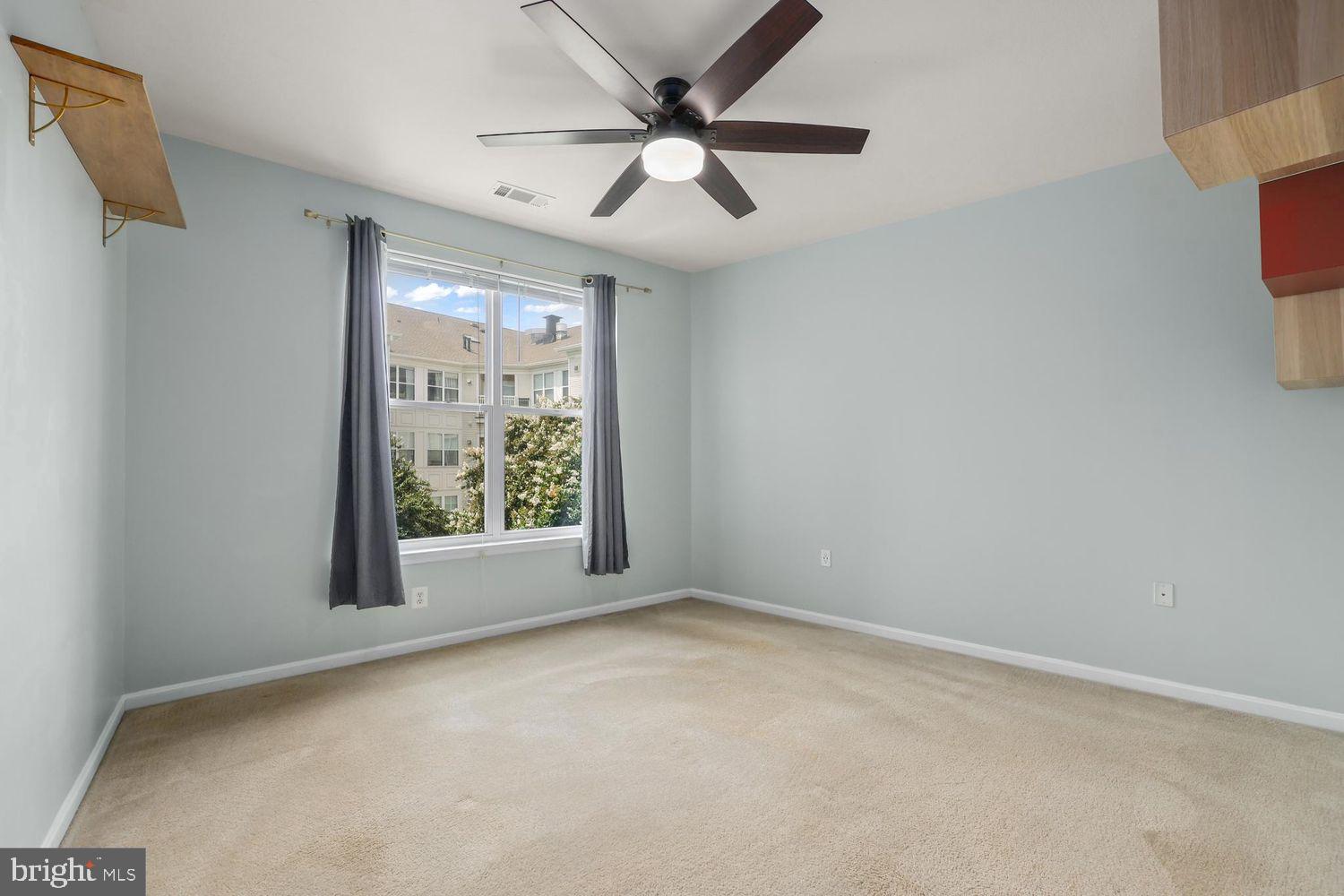 9480 Virginia Center Boulevard, Unit 329 Vienna, VA 22181 - Photo 15 of 30 an empty room with windows and fan