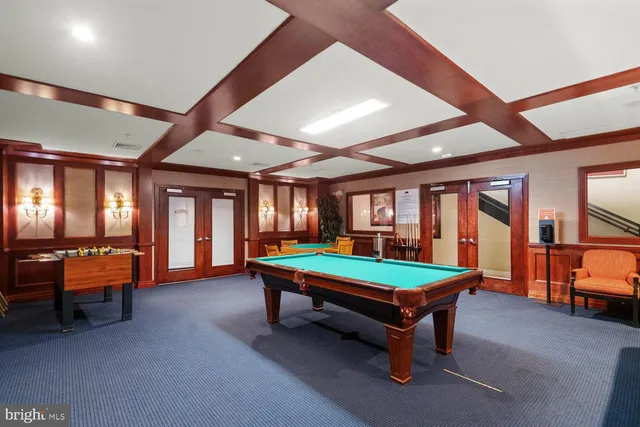 a room with pool table and windows