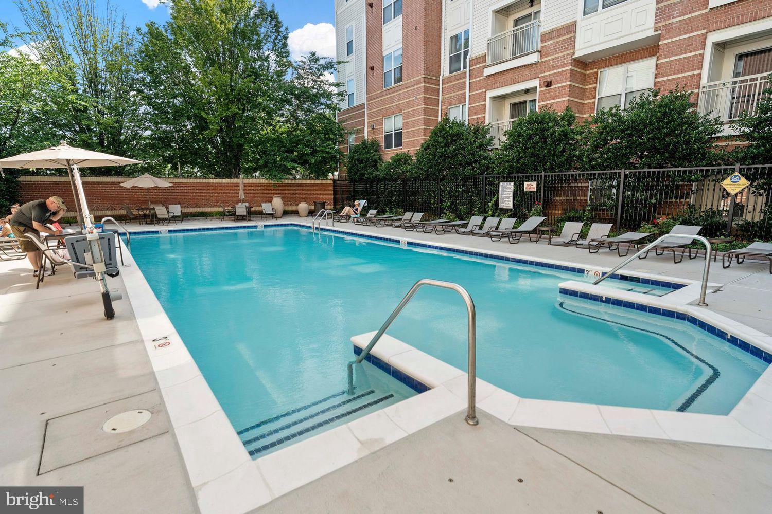 9480 Virginia Center Boulevard, Unit 329 Vienna, VA 22181 - Photo 25 of 30 a view of a swimming pool with a lounge chairs