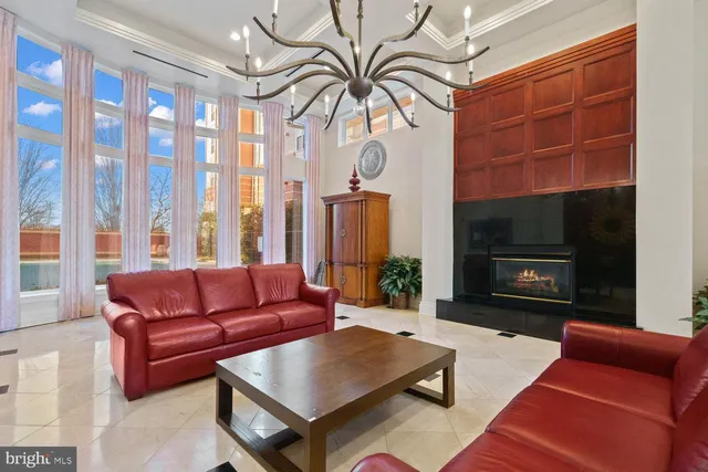 a living room with furniture a fireplace and a window