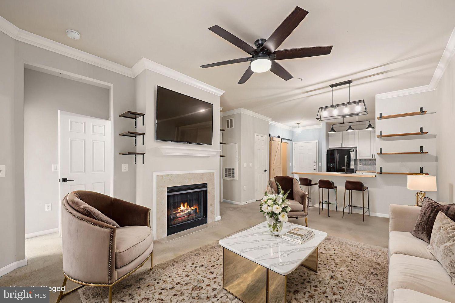 9480 Virginia Center Boulevard, Unit 329 Vienna, VA 22181 - Photo 4 of 30 a living room with furniture a fireplace and a flat screen tv