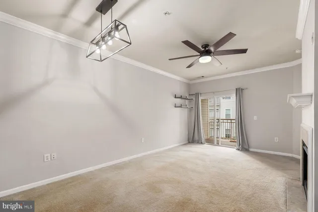 a view of a livingroom with a ceiling fan and window