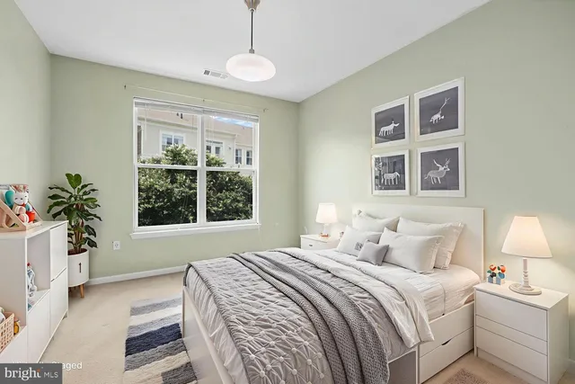 a bedroom with a large bed and a window