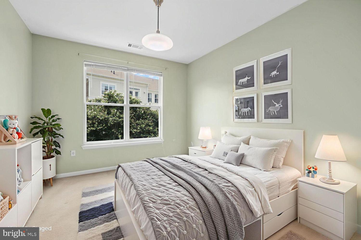 9480 Virginia Center Boulevard, Unit 329 Vienna, VA 22181 - Photo 9 of 30 a bedroom with a large bed and a window