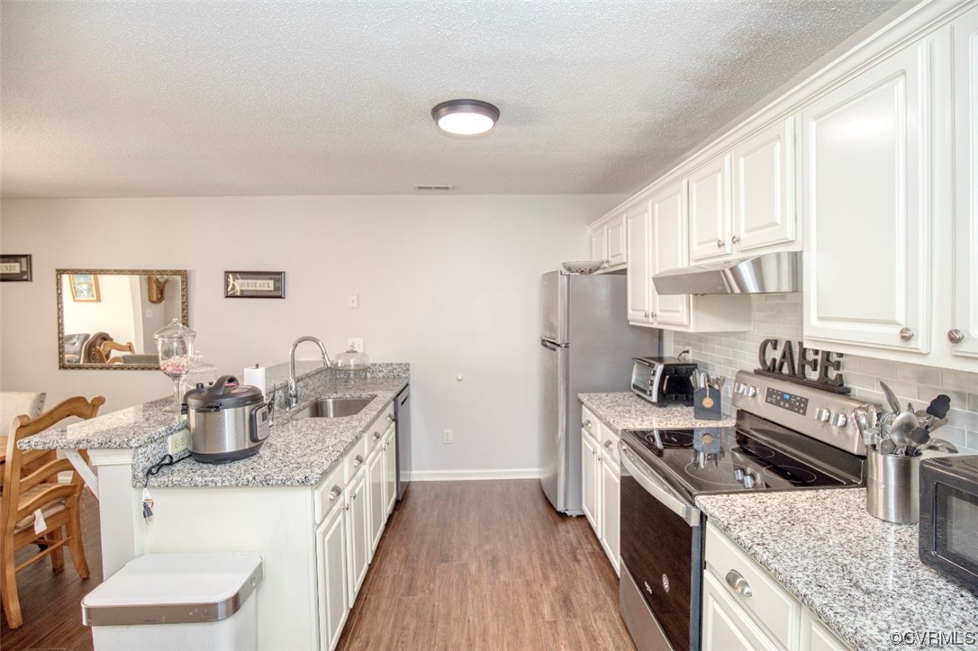 1403 Westgate Circle Williamsburg, VA 23185 - Photo 12 of 42 a kitchen with a stove a sink and a refrigerator