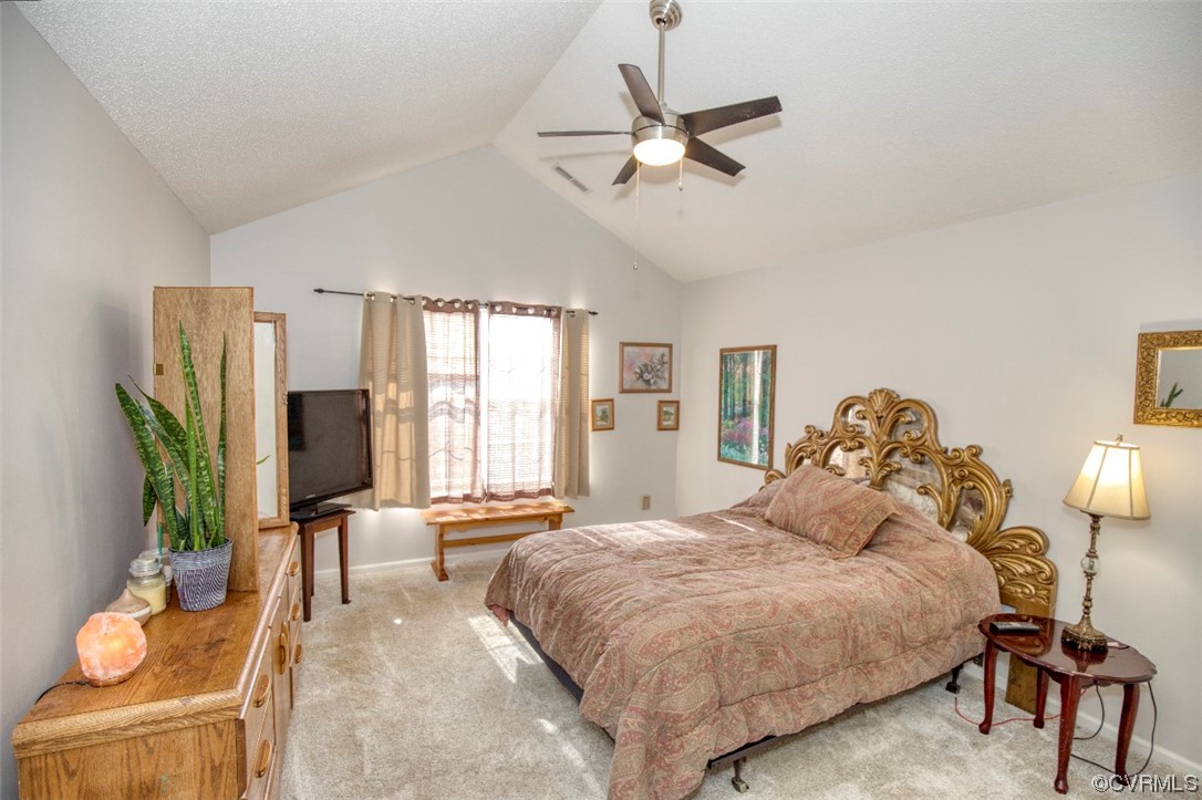 1403 Westgate Circle Williamsburg, VA 23185 - Photo 34 of 42 a spacious bedroom with a bed and a chandelier