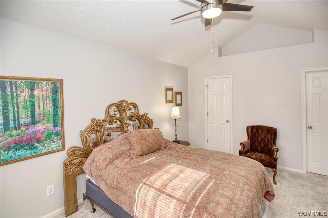 1403 Westgate Circle Williamsburg, VA 23185 - Photo 42 of 42 a bedroom with a bed and a chandelier