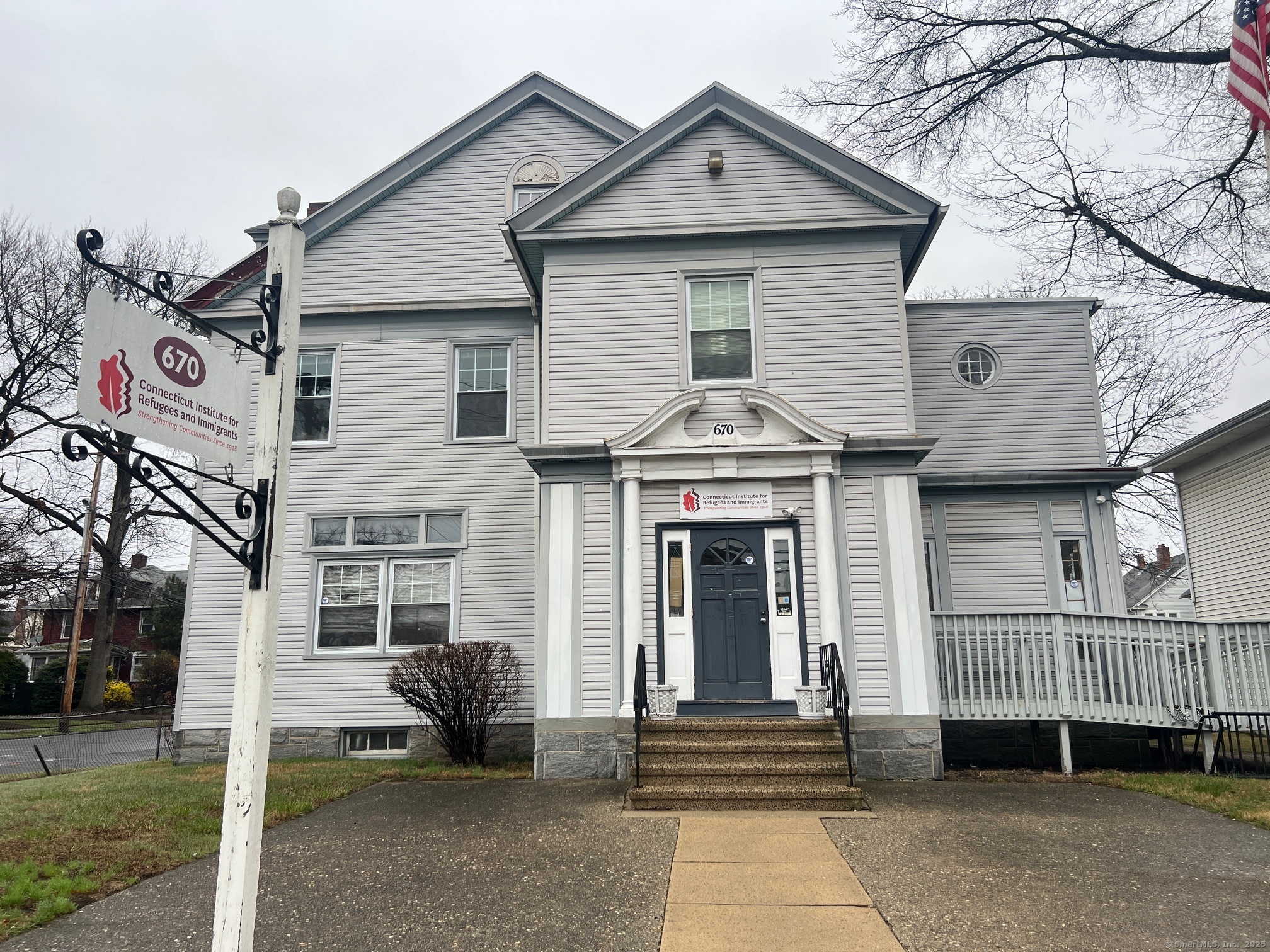 670 Clinton Avenue Bridgeport, CT 06605 - Photo 1 of 6 a view of a white house with iron fence