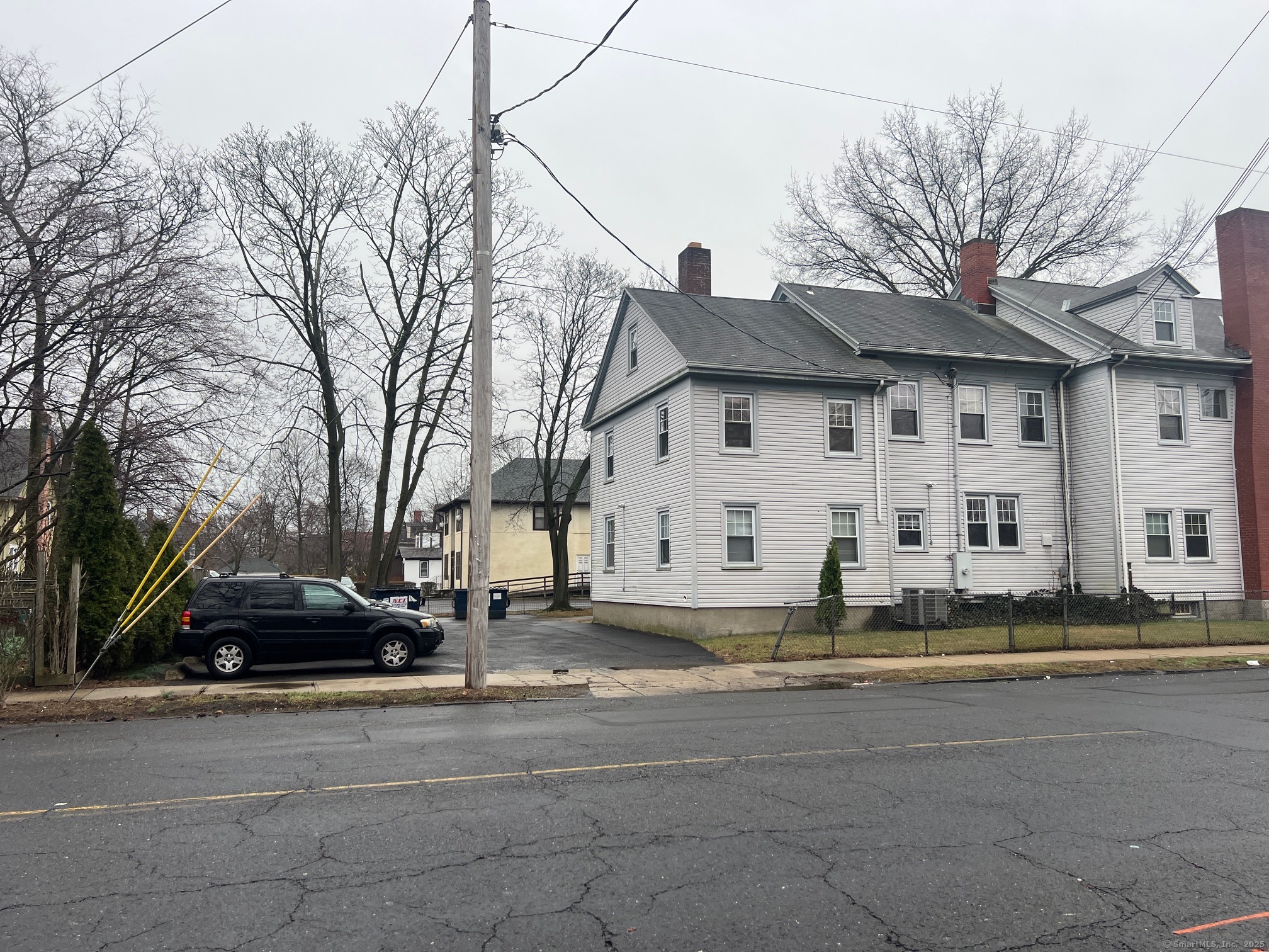 670 Clinton Avenue Bridgeport, CT 06605 - Photo 6 of 6 a view of a white house with a large tree