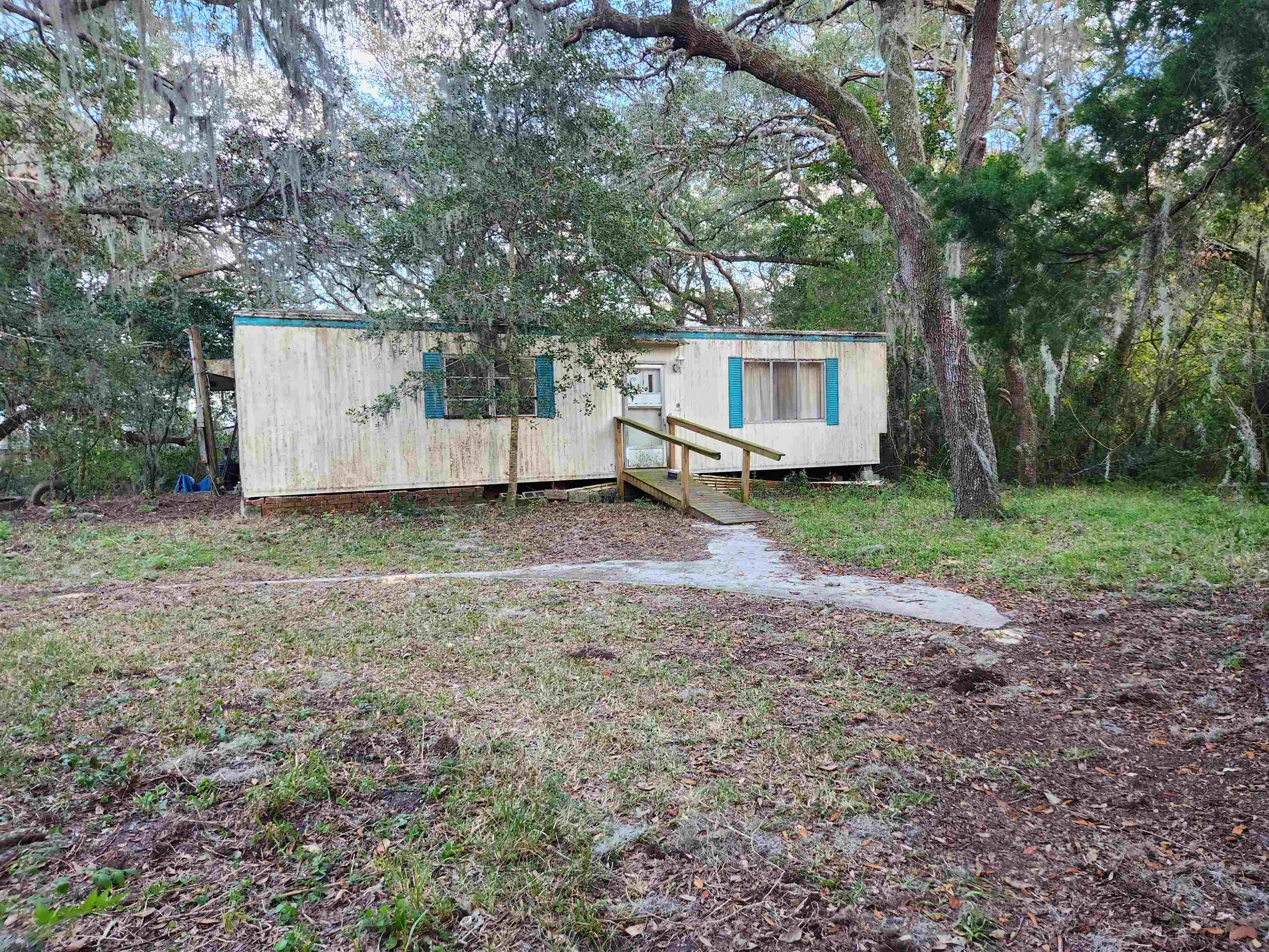 2890 Old Moultrie Road St. Augustine, FL 32086 - Photo 2 of 7 a view of a house with a yard and large trees
