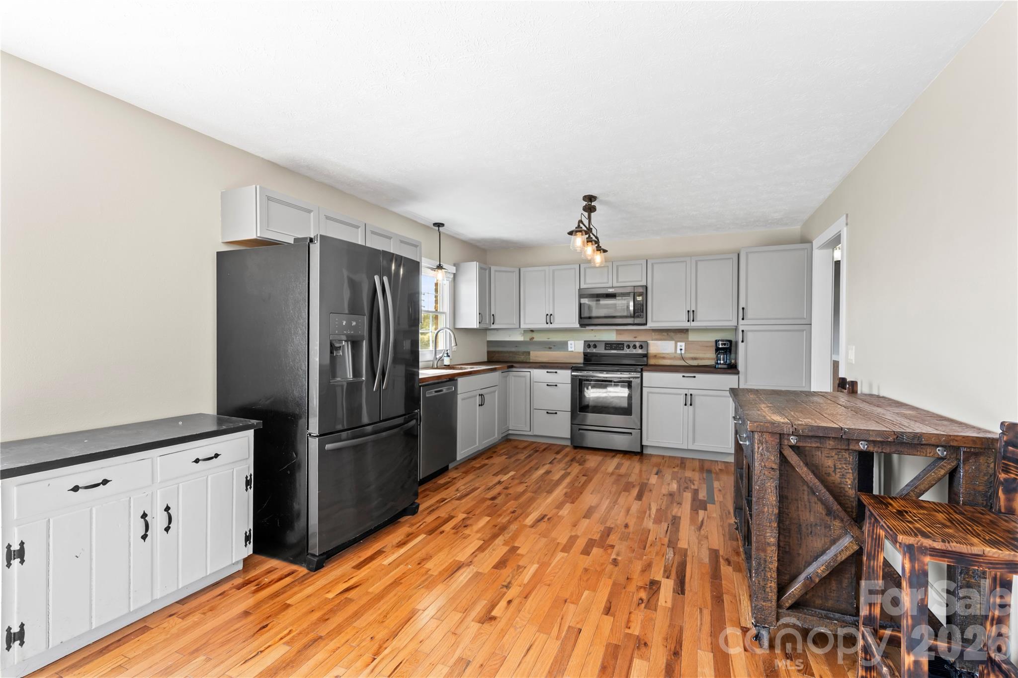 882 Queentown Road Canton, NC 28716 - Photo 12 of 33 a kitchen with granite countertop a refrigerator stove top oven and sink