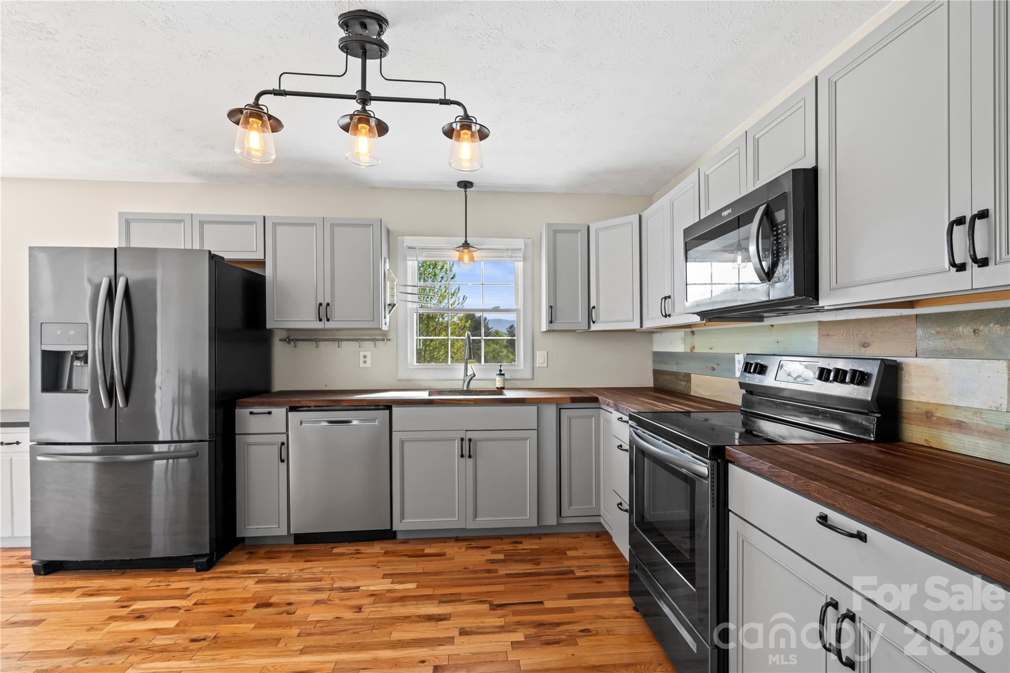 882 Queentown Road Canton, NC 28716 - Photo 13 of 33 a kitchen with stainless steel appliances granite countertop a stove a sink dishwasher a refrigerator and a microwave