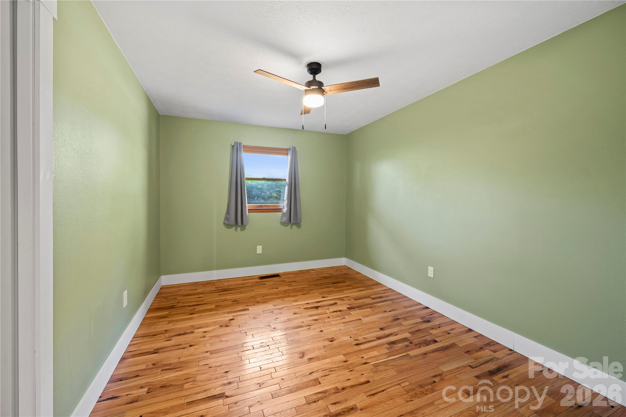 882 Queentown Road Canton, NC 28716 - Photo 16 of 33 a view of a big room with wooden floor and windows